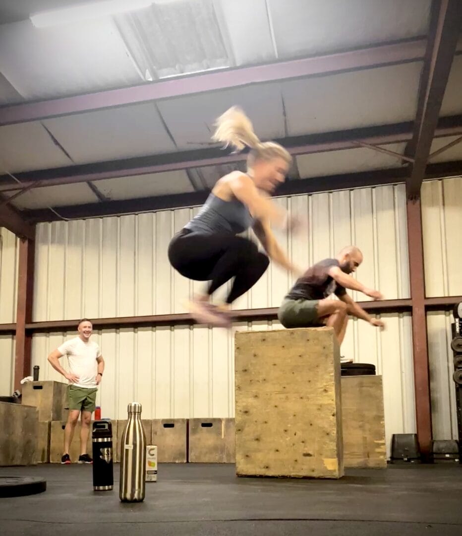 A strong woman and mom jumps high in her workouts with friends at Black Wolf CrossFit in Oak Forrest, Independence Heights, Houston.